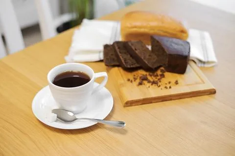 Coffee cup and bread on the table Photos