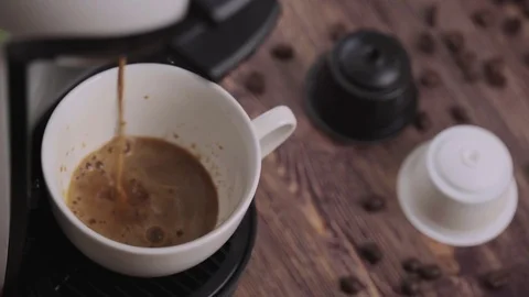 Coffee cup and capsules on a rustic wooden table 스톡 동영상 84771954