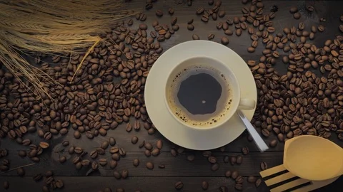 Coffee cup and coffee beans on a black wooden table Stock Footage 107939667
