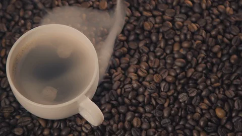 Coffee cup and coffee beans. A white cup of evaporating coffee on the table with Stock Footage 126418767