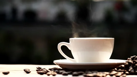 Coffee cup and coffee beans with natural steam smoke of coffee Stock Footage 148026309