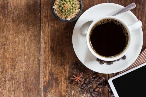 Coffee cup and coffee beans on wooden table Stock Photos
