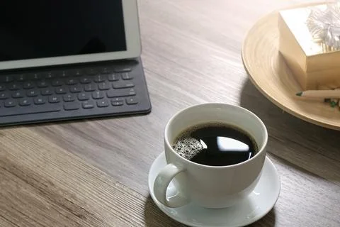 Coffee cup and Digital table dock smart keyboard,gold gift box and round wo.. Фото