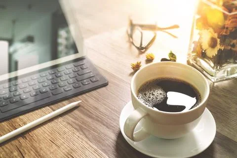 Coffee cup and Digital table dock smart keyboard,vase flower herbs,stylus p.. Stock Photos