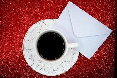 Coffee cup and envelope on red background Stock Photos