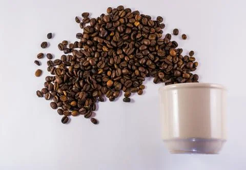 Coffee Cup and Exploding Roasted Beans Stock Photos
