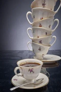 Coffee cup and precarious stack of cups Photos