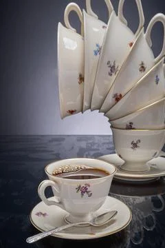 Coffee cup and precarious stack of cups Photos