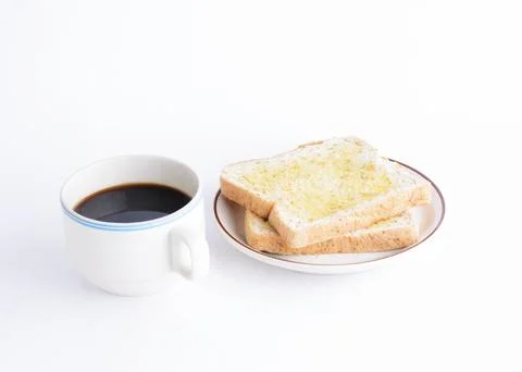 Coffee cup and sliced bread on white background Foto stock