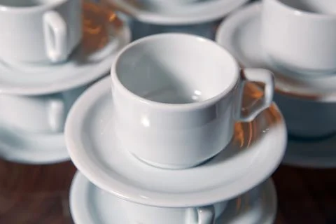 Coffee cup and spoon setting on white saucer and wooden table after drinking  Stock Photos