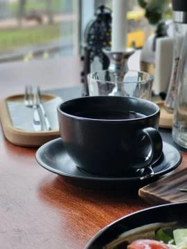 Coffee Cup and Tableware in Modern Cafe Interior Stock Photos