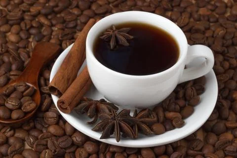 Coffee in a cup on the background of coffee beans Stock Photos