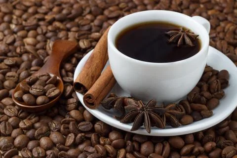 Coffee in a cup on the background of coffee beans Stock Photos