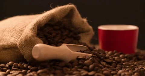 Coffee cup with Bag and scattered coffee beans rotating composition video Stock Footage 98046053