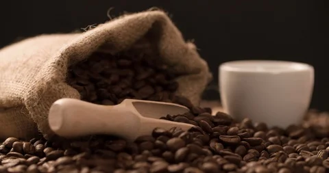 Coffee cup with Bag and scattered coffee beans rotating composition Stock Footage 98046381