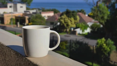 Coffee cup on a balcony with ocean view Stock Footage 313932471