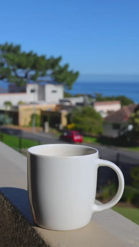 Coffee cup on a balcony with ocean view Stock Footage 313932742