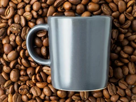 Coffee cup with beans on the background. Stock Photos