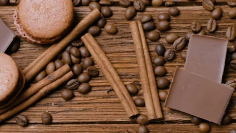 Coffee cup, beans, chocolate and macaroons on the table. Stock Footage 88435512