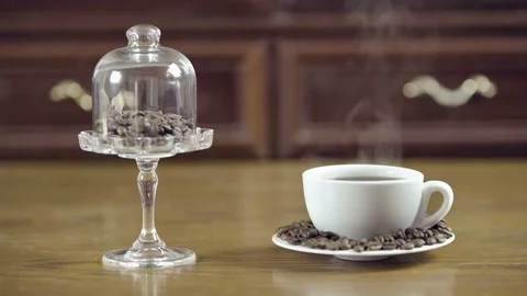 Coffee cup with beans on a decorative stand Stock Footage