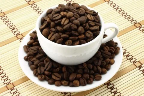 Coffee cup with beans Stock Photos