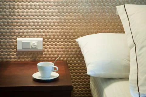 Coffee cup on bedside table 스톡 사진