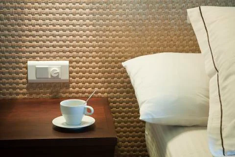 Coffee cup on bedside table Stock Photos