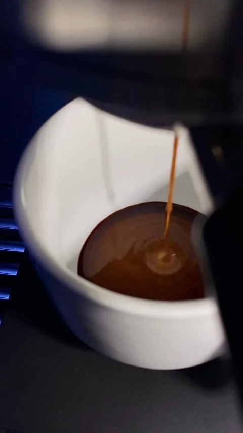 A coffee cup being poured into a cup Stock Footage 296284737