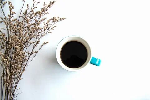 The coffee cup with black coffee put beside dried flower,on white background Foto stock