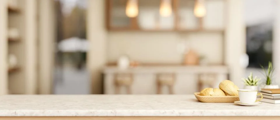 Coffee cup with breads on marble table across counter bar and cupboard in a.. Illustration