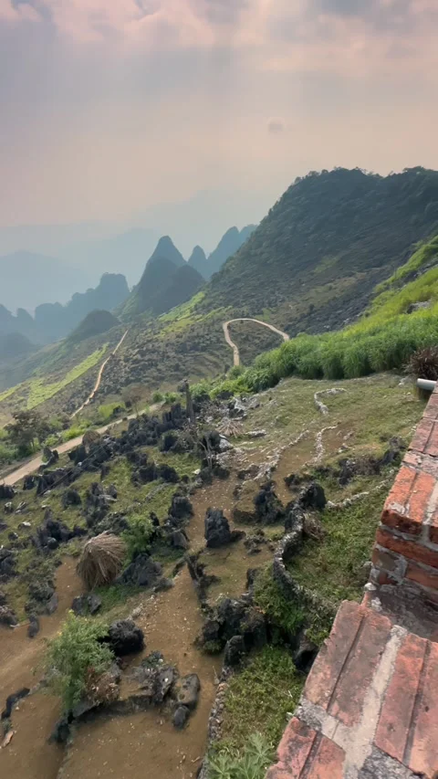 Coffee cup on brick wall overlooking Dong Van Karst Plateau, Ha Giang, VN, Video stock 329072411