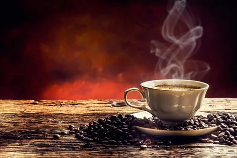 Coffee. Cup of coffee and coffee beans. Vintage cup and old oak table Stock Photos