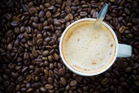 Coffee cup on coffee bean background Stock Photos