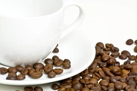 Coffee cup with coffee bean on table Stock Photos