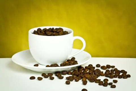 Coffee cup with coffee bean on table Stock Photos