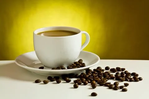 Coffee cup with coffee bean on table Stock Photos