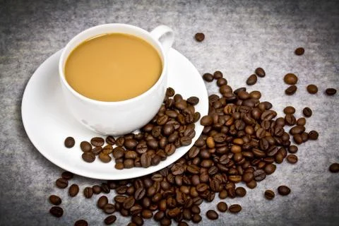 Coffee cup with coffee bean on table Stock Photos