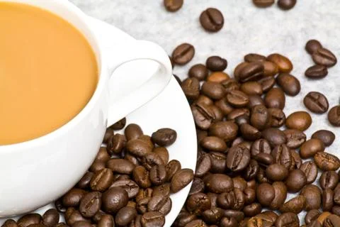 Coffee cup with coffee bean on table Stock Photos