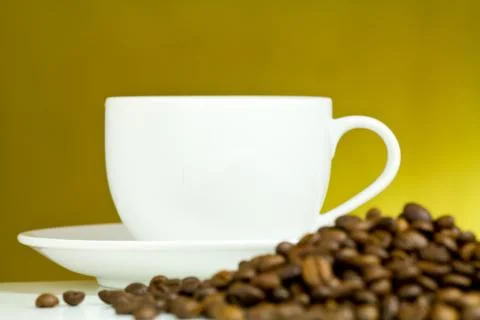 Coffee cup with coffee bean on table Stock Photos