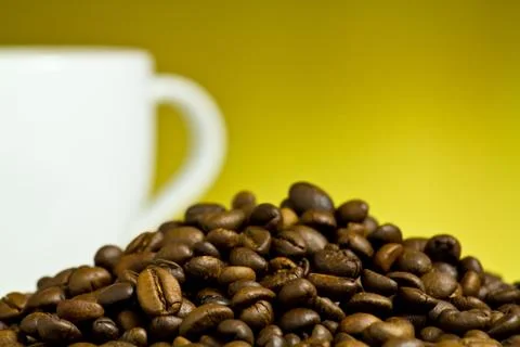 Coffee cup with coffee bean on table Stock Photos