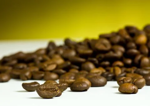 Coffee cup with coffee bean on table Stock Photos