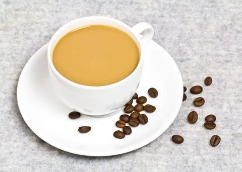 Coffee cup with coffee bean on table Stock Photos