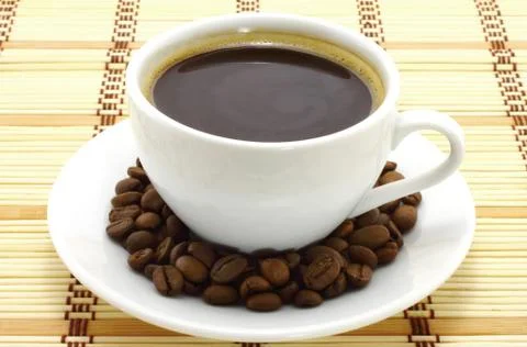 Coffee cup with coffee beans Stock Photos