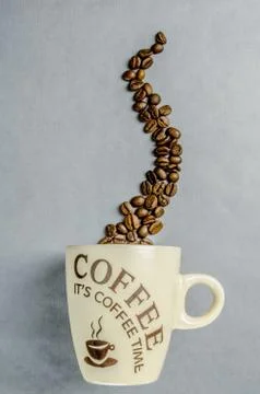 Coffee cup with coffee beans Stock Photos