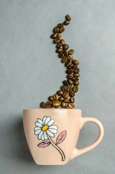 Coffee cup with coffee beans Stock Photos