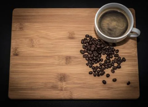 Coffee cup with coffee beans on a rustic wooden background Stock Photos