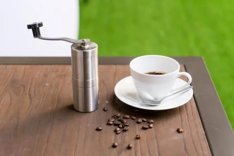Coffee cup with Coffee grinder on table Stock Photos