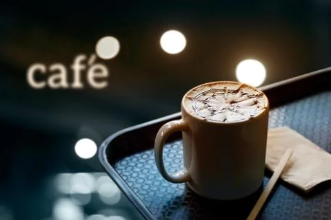 Coffee cup with design pattern in a white cup on tray and and text cafe 스톡 사진