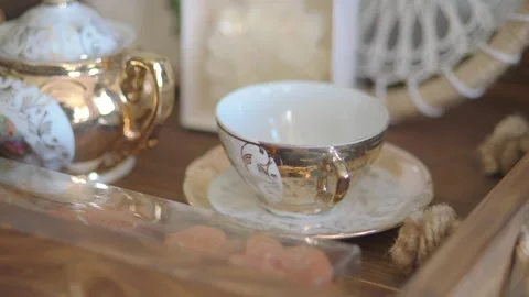 Coffee cup displayed on wooden table with decor items Stock Footage 338041812