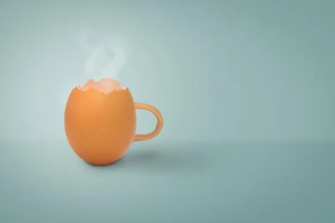 Coffee cup from egg shell with smoke on pastel blue background w Stock Photos